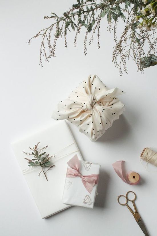 Confezioni regalo di Natale bianchi realizzati con carta e stoffa