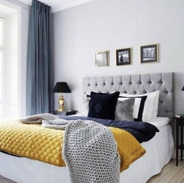Tessili e dettagli di stile per una camera da letto in grigio e giallo